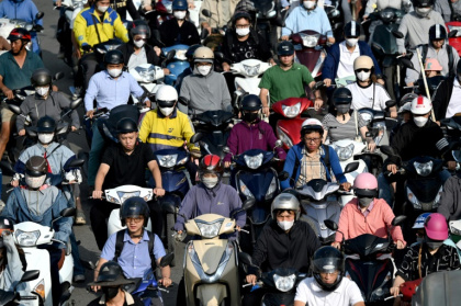 Des conducteurs de deux-roues dans une rue de Hanoi, le 17 juillet 2025 - Nhac NGUYEN (AFP)
