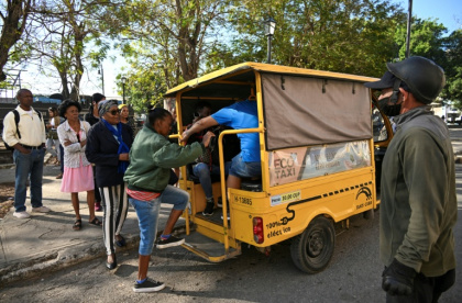 Des personnes font la queue pour monter dans un triporteur électrique à La Havane, Cuba, le 13 février 2026 - YAMIL LAGE (AFP)