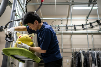 Masakazu Shimura nettoie à la vapeur une peluche Pikachu à Fuefuki, au Japon, le 27 avril 2026 - Philip FONG (AFP)